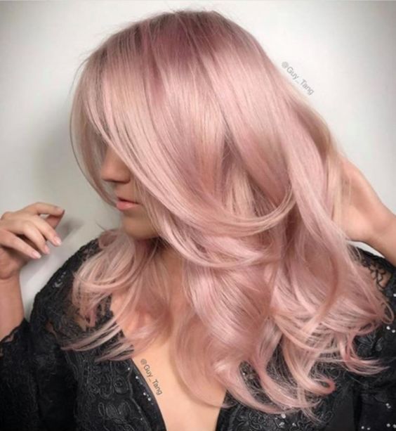 a peachy rose gold wavy hairstyle with long waves and a volume on top is amazing if you are looking for a soft touch to your look