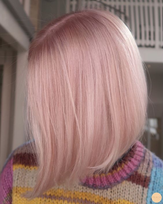 a shiny peachy rose blonde bob with central parting and straight hair is fantastic for anyone who loves such shades
