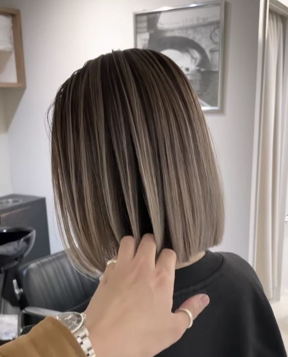 a short mushroom brown bob with a darker root is a stylish idea to try right now, it looks caatchy and lovely