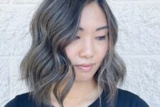 a wavy long bob in mushroom brown, with a darker root, delicate beige blonde highlights and a hint of gray