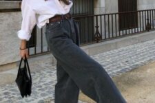 a white shirt, black wide leg jeans, black sneakers, a black bag and a brown belt are a cool and contrasting combo
