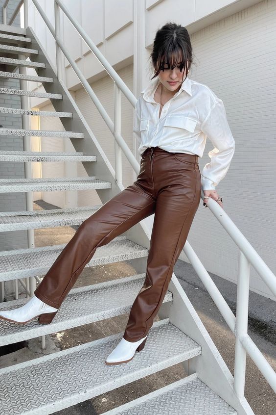 a white shirt with pockets, brown leather pants and white cowboy boots for a creative and cool office look