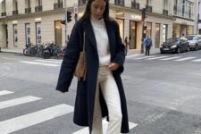 a white sweater and jeans, black sneakers, a black coat, a beige bag are a simple monochromatic look for the transitional time