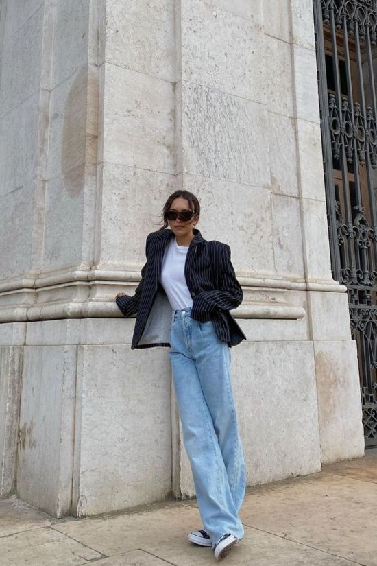 a white t shirt, a black striped blazer, light blue wide leg jeans, black sneakers are a perfect spring look