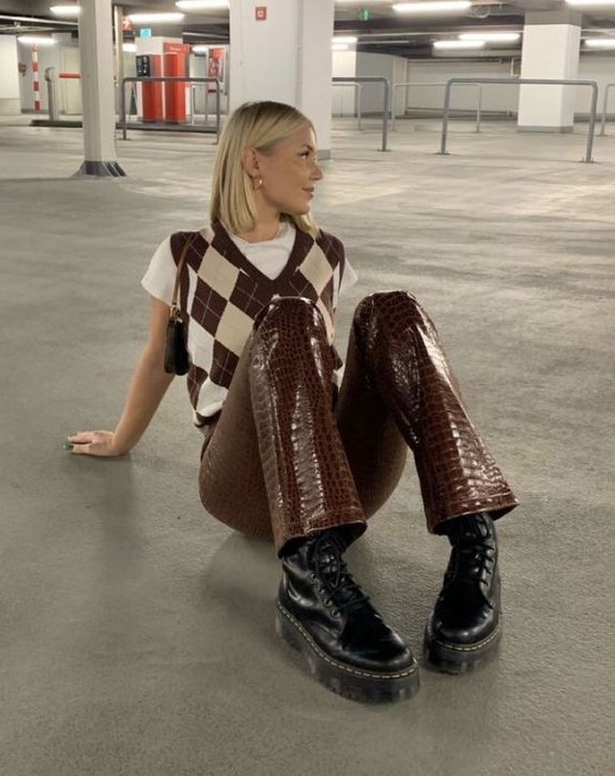 a white t-shirt, a printed knit waistcoat, brown crocodile leather pants, black boots and a small bag