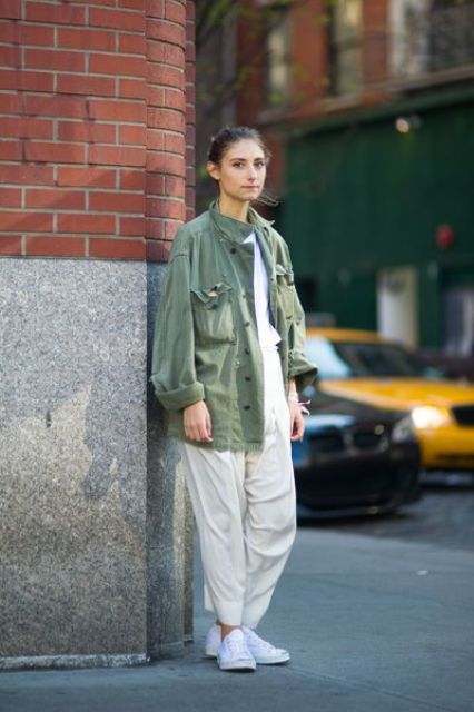 a white t shirt, neutral pants, white sneakers and a green utility jacket with black buttons for a comfy look