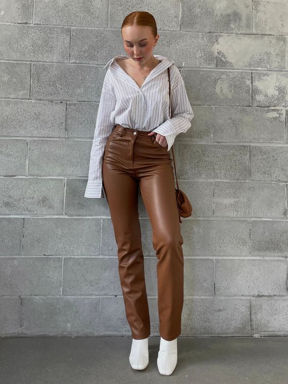 a white thin stripe shirt, brown leather pants, white boots and a brown suede mini bag for every day