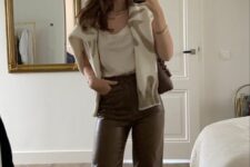 a white top, brown leather trousers, a printed sweater, white sneakers and a brown bag are a lovely and chic everyday look
