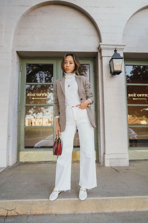 a white turtleneck, wideleg jeans, loafers, a greige blazer and a small red bag to rock this spring