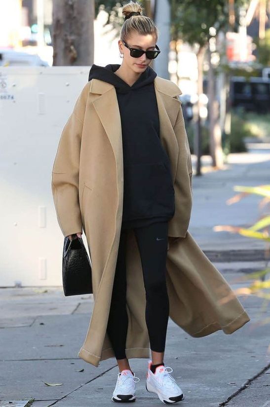 an oversized black hoodie and leggings, white trainers, a beige maxi coat and a black bag are pure comfort