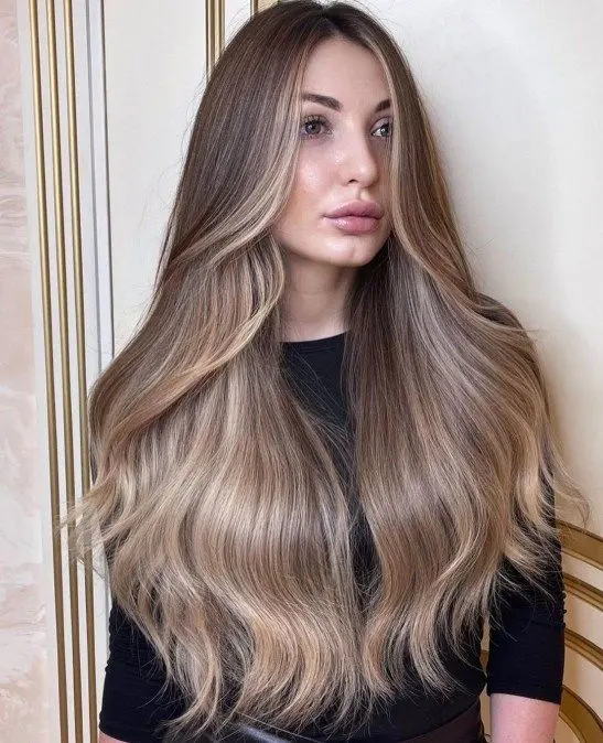 beautiful long and shiny mushroom brown hair with blonde lowlights and slight waves is a lovely idea to show all the beauty of your hair