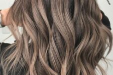 beautiful long and wavy mushroom brown locks with a darker root are amazing to rock this new and trendy hair color