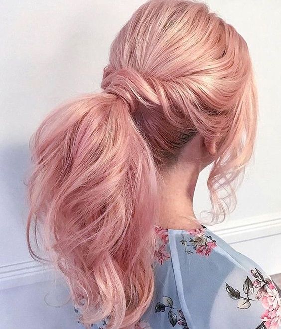 long shiny peachy rose gold hair in a ponytail, with waves, face-framing locks and a volume on top is adorable