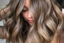 wavy mushroom brown medium length hair with cold blonde highlights is a beautiful solution to try for spring or summer