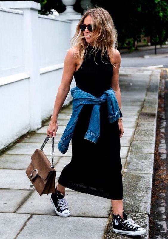 a black halter neckline maxi dress, a blue denim jacket, black high top sneakers, a brown bag with chain for spring