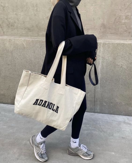 a comfy outfit with a grey turtleneck, black leggings, an oversized blazer, grey trainers and white socks, a neutral canvas bag