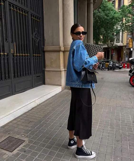 a black midi skirt, a blue denim jacket, black high top sneakers and a small black bag are all you need for spring