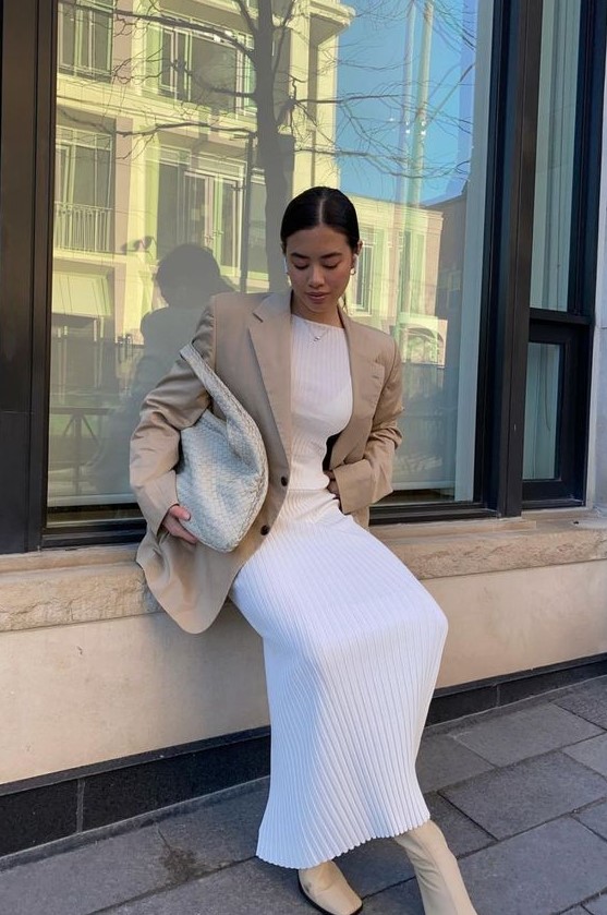 a white pleated midi dress, a tan oversized blazer, a white woven bag, creamy square toe boots for a chic and girlish look