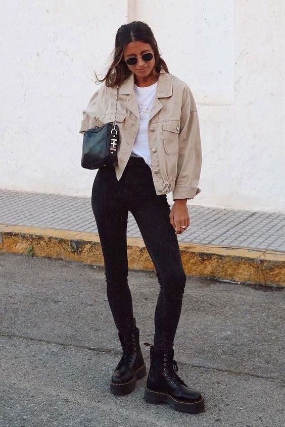 a white t-shirt, black skinnies, black combat boots, a black bag and a cropped oversized tan denim jacket