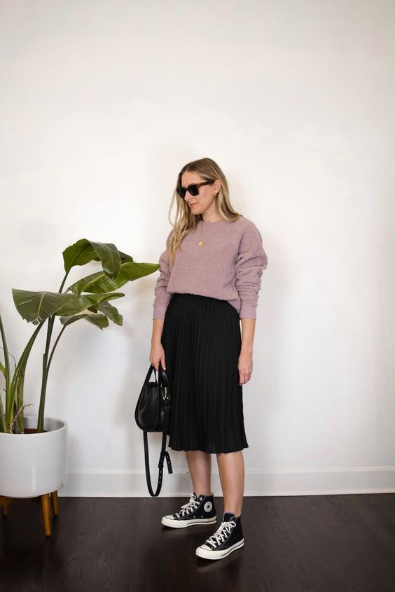a mauve long sleeve top, a black pelated midi skirt, black high tops and a black bag are a creative look for spring