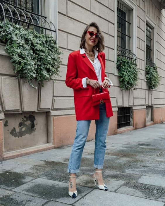 a white button down, an oversized red blazer, blue jeans, two-tone shoes and a small red bag for spring