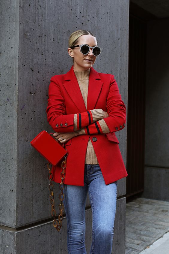 a tan turtleneck, a red blazer and a bag with chain, blue jeans for a cold spring daty or for winter
