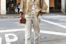 10 a wihte t-shirt, neutral linen pants, grey loafers, a tan cropped denim jacket and a brown crossbody bag