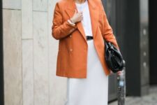 10 whimsy black shoes, a white tee, a white midi skirt, an orange oversized blazer and a large black clutch