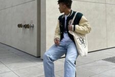 11 a white t-shirt, a black and creamy bomber jacket, bleached jeans, white sneakers and a neutral canvas bag for spring