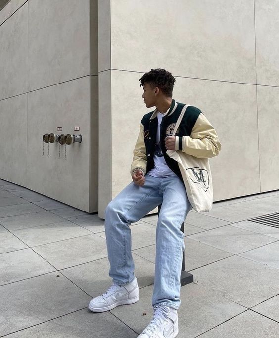 a white t shirt, a black and creamy bomber jacket, bleached jeans, white sneakers and a neutral canvas bag for spring