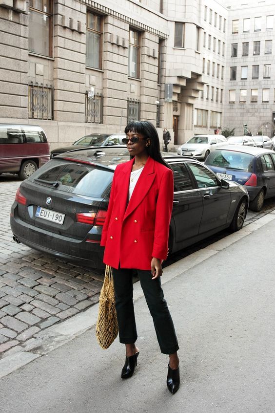 a white one shoulder top, an oversized red blazer, black pants, black heels and a woven bag for spring