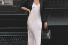 12 a white slip midi dress, a black oversized blazer, strappy shoes, a clear bag and a necklace with a pearl for a chic look