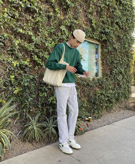 a white t shirt, a green sweatshirt, white jeans, white and green sneakers, a neutral canvas bag and a neutral beanie for spring