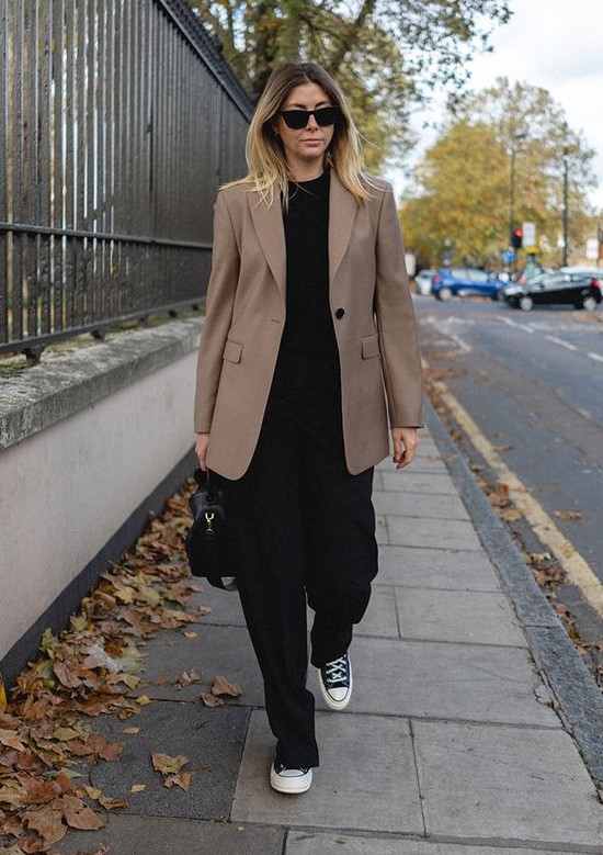 a catchy look with a black t-shirt, black pants, black sneakers, a beige oversized blazer and a black bag can be a fit for work
