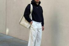 14 white trousers, a neutral tree, a black hoodie, neutral trainers and a neutral canvas bag for spring days