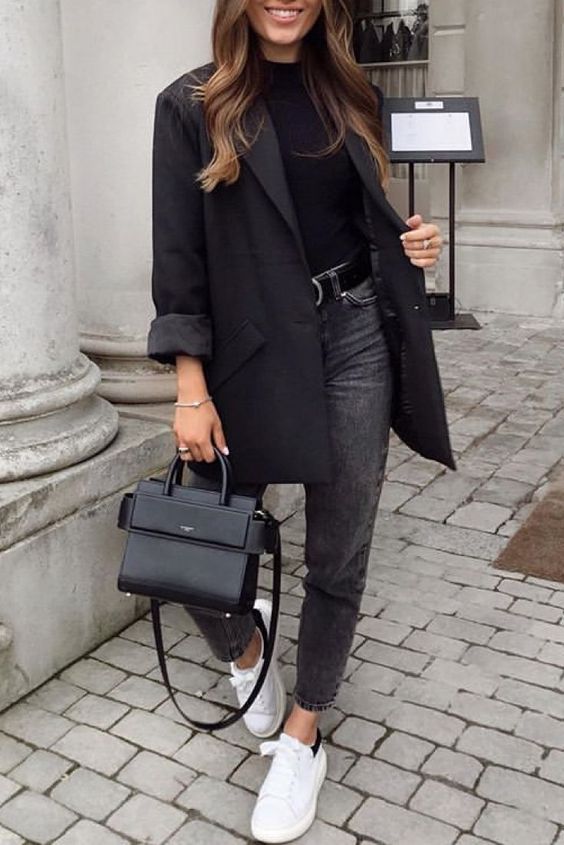 a black t-shirt, oversized blazer, bag, grey jeans, a black belt and white sneakers are a great spring work look
