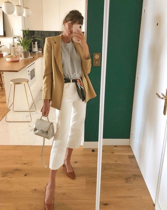 a grey t-shirt, an oversized beige blazer, white culottes, brown shoes and a small grey bag for a simple work look