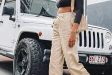 17 a black long sleeve crop top, tan jeans, black chunky boots, a beige bag for spring