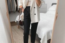 17 a monochromatic spring work look with a neutral top, a creamy oversized blazer, black pants, black sock boots and a brown bag