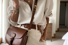 18 a neutral lok with a zip polo shirt, neutral shorts, a brown belt and a brown crossbody bag