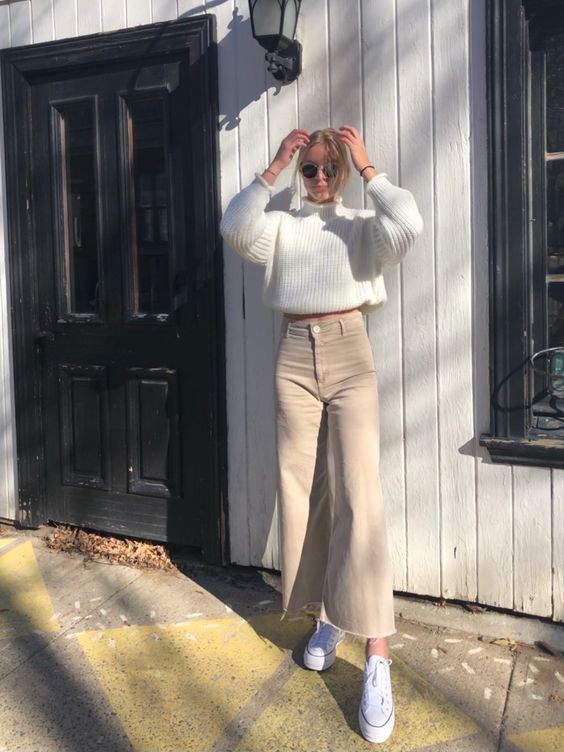 a creamy ribbed sweater, tan flare jeans, white sneakers for a lovely winter to spring look