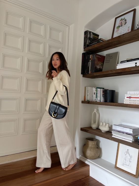 a neutral jumper and trousers, a black crossbody bag are a great solution for spring
