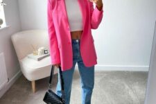 19 a simple and sexy outfit with a white crop top, blue jeans, white sneakers, a bright pink blazer and a black bag with chain