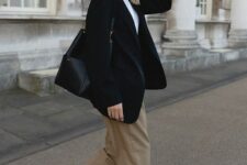 19 a smart casual look with a white shirt, taupe pants, white sneakers, an oversized black blazer and a bag, chic watch