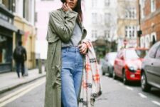 19 a spring look with a grey t-shirt, blue cuffed jeans, a green trench, black Adidas sneakers and black socks is easy to repeat