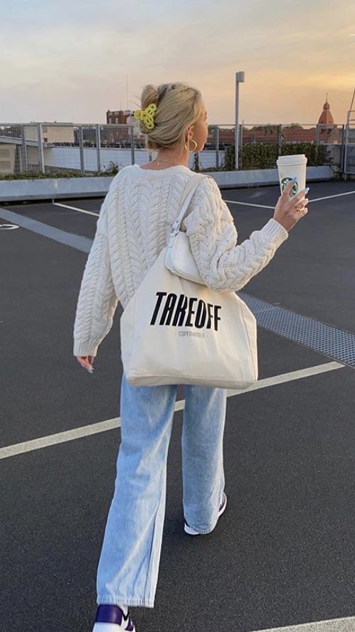 a creamy chunky knit cardigan, bleached blue jeans, purple sneakers, a white mini bag and a neutral canvas bag