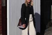 20 a fall work look with a black turtleneck and an oversized blazer, white wideleg jeans, black shoes and a woven bag