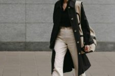 20 a monochromatic spring outfit with a black shirt, white jeans, black sneakers, a black trench and a large printed bag
