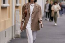 20 a stylish and elegant outfit with a white t-shirt, trousers, white strappy heels and a brown bag