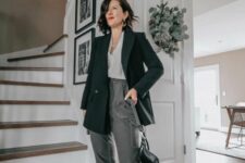 21 a chic outfit with grey pants, a black blazer, a white top, black strappy heels and a small black bag plus statement earrings